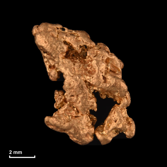 Goldnugget Nr. 26-0157 mit Maßstab: 9,4 × 8,0 mm bei 0,85 g
