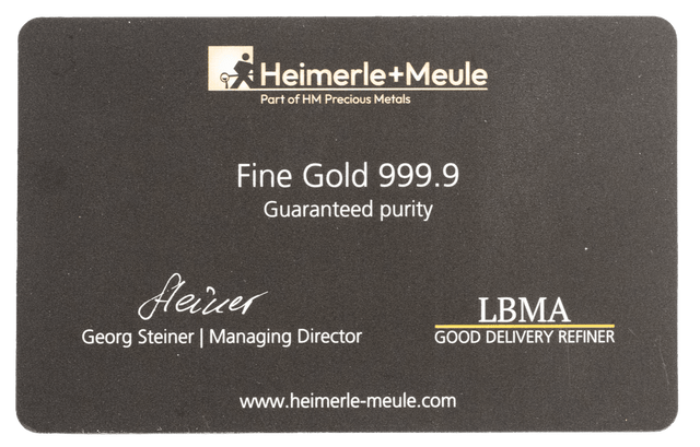 Die Rückseite Heimerle + Meule Secain Card mit 1/200 oz Feingold Barren Reinheit 999.9 in edler schwarzer Blisterkarte