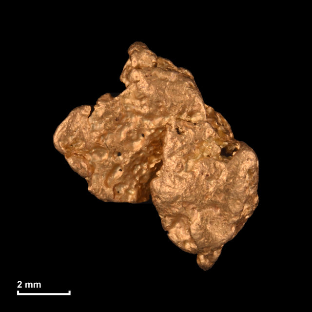 Goldnugget Nr. 26-0129 mit Maßstab: 8,6 × 7,7 mm bei 0,87 g